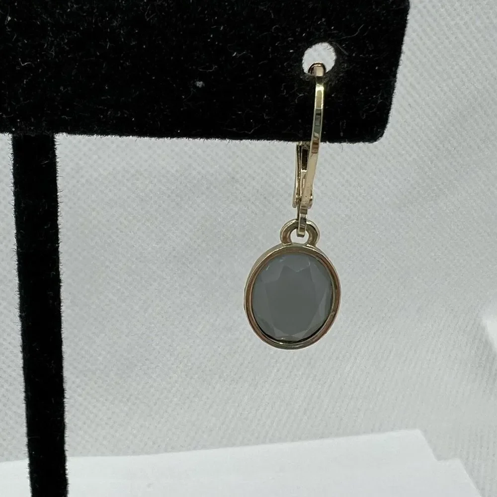 Faceted blue grey hinge dangle earrings on gold tone backing